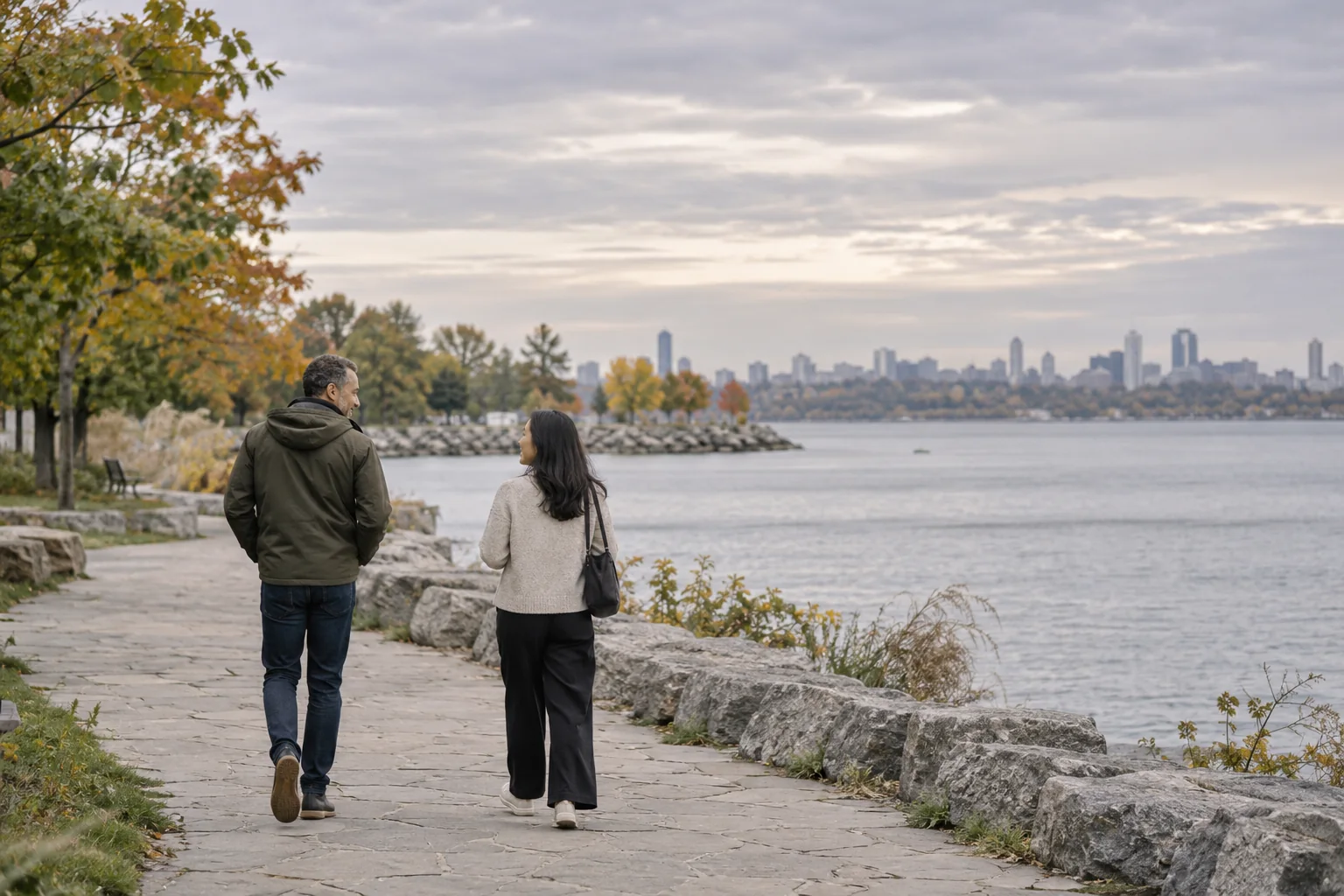 Two adults in conversation beside a waterfront.
